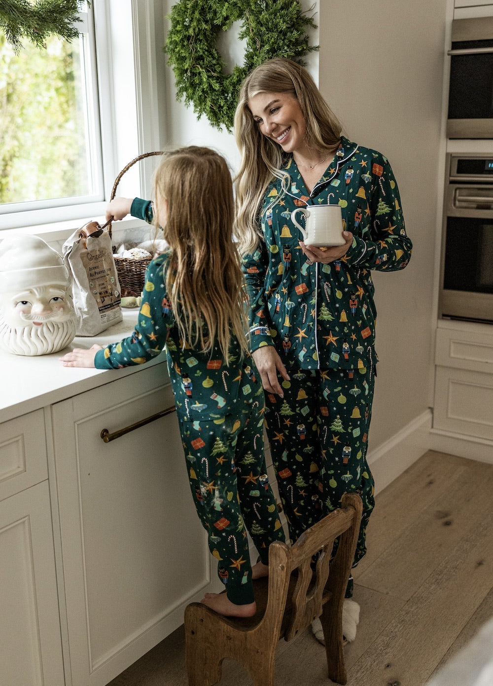Woman and child in matching pajamas in a kitchen