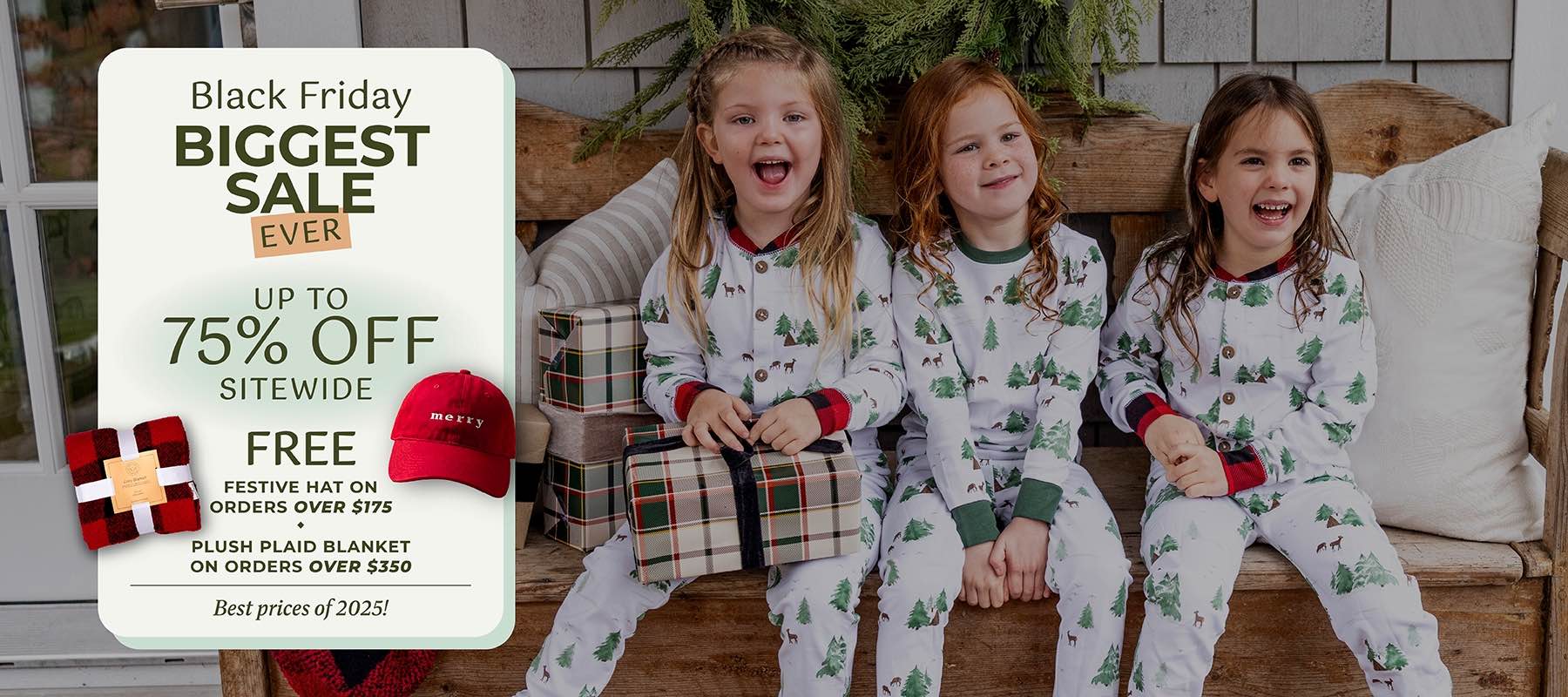 Three children in matching pajamas with a Black Friday sale sign.
